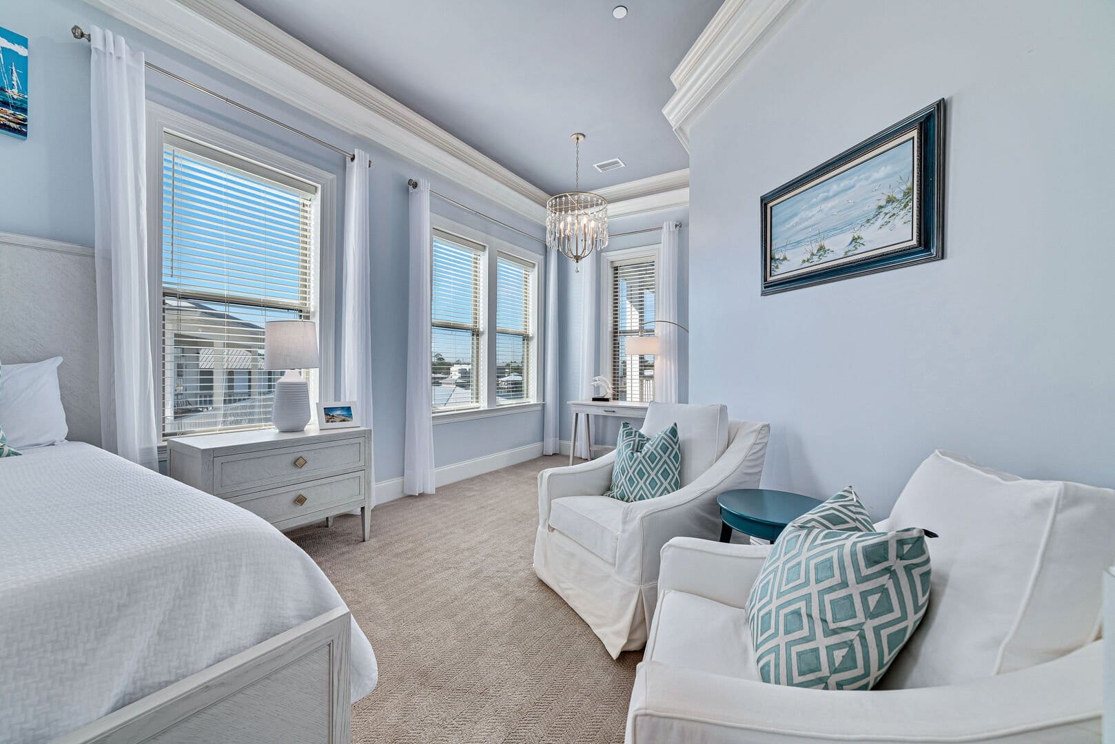 Bright, elegant bedroom with seating.