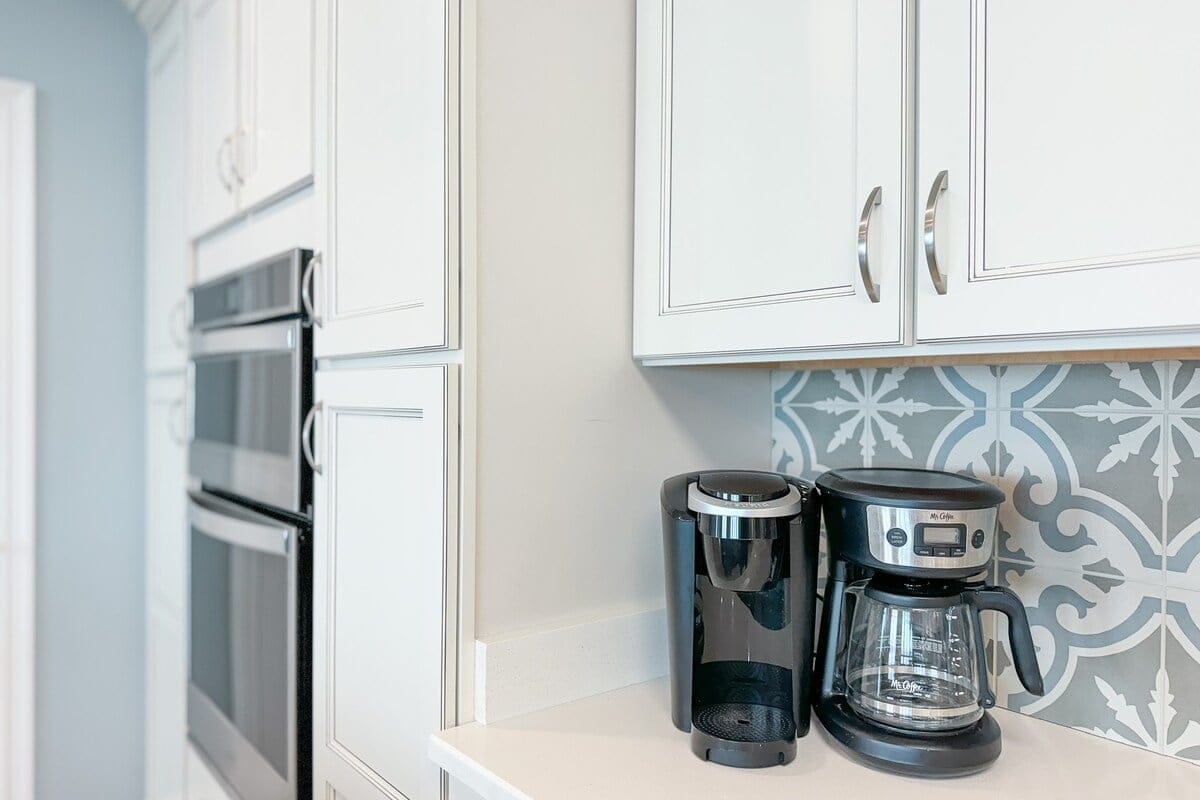 Kitchen corner with coffee makers.