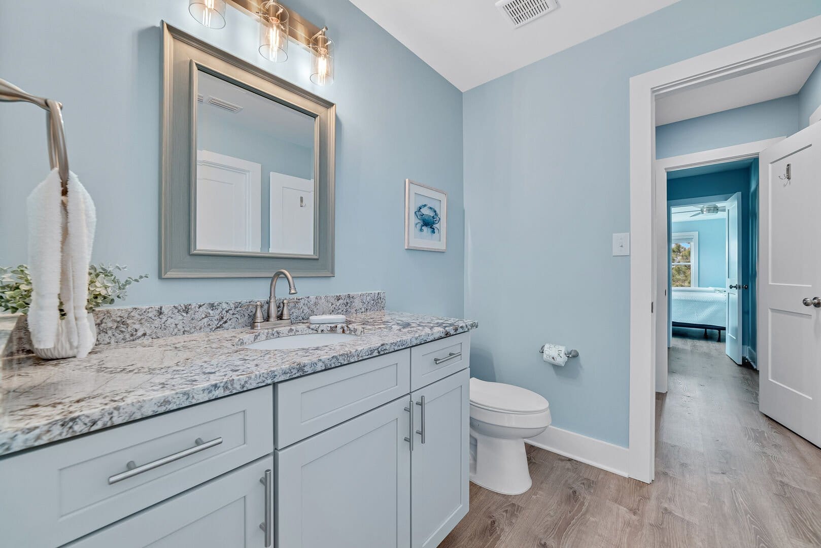 Light blue bathroom, marble countertop.