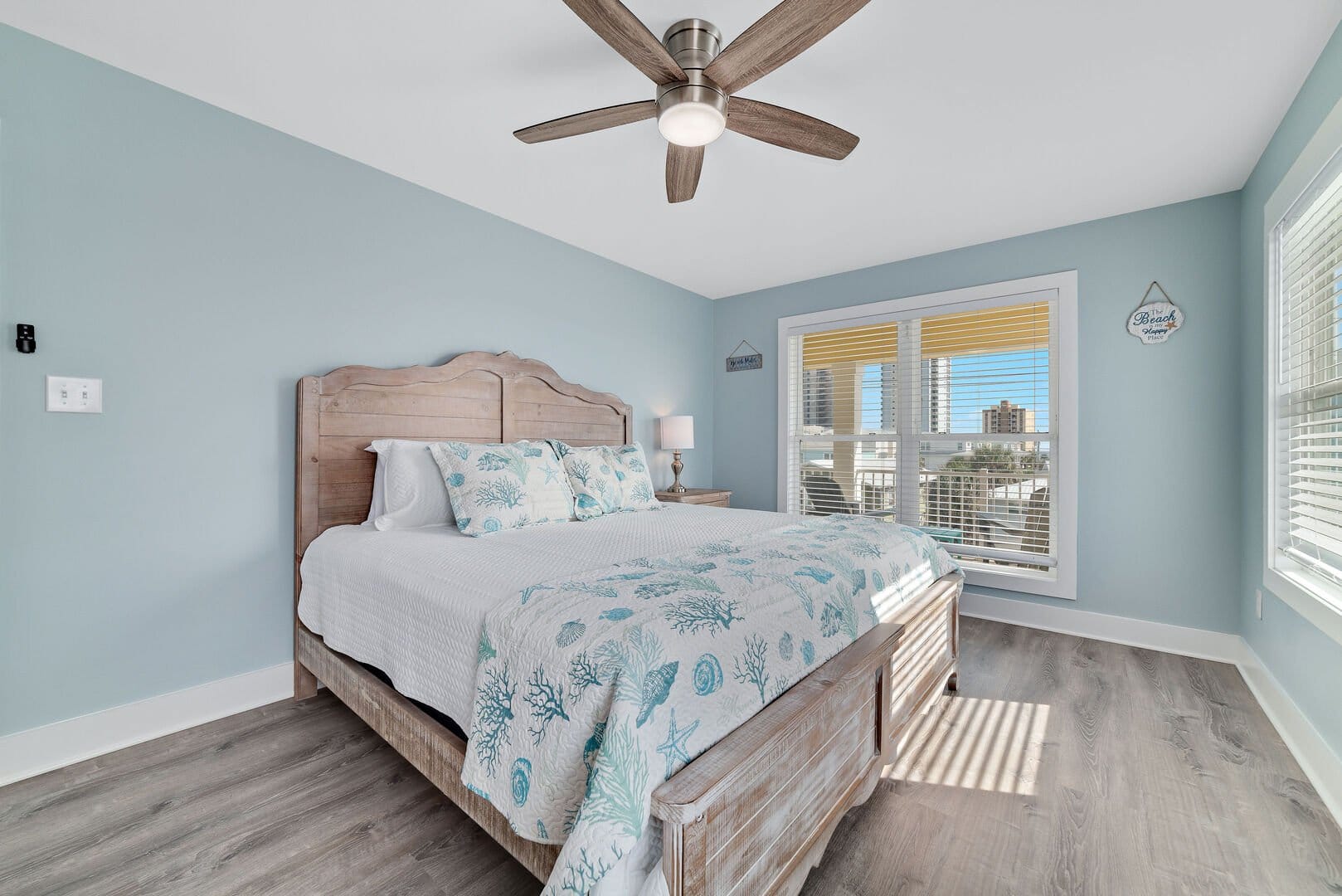 Coastal-themed bedroom with large window.