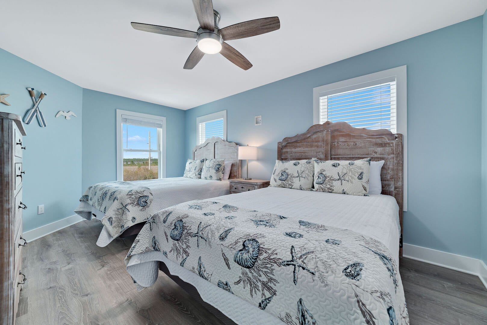 Beach-themed bedroom with two beds.