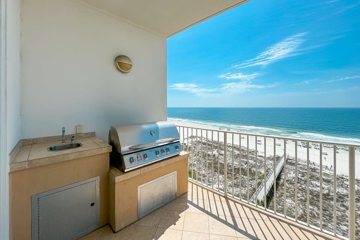 Balcony with grill overlooking ocean.