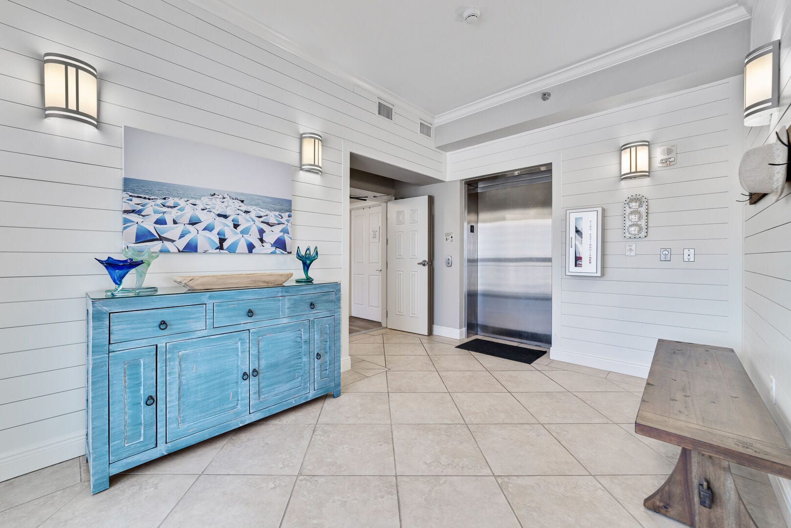 Coastal-themed hallway with elevator.