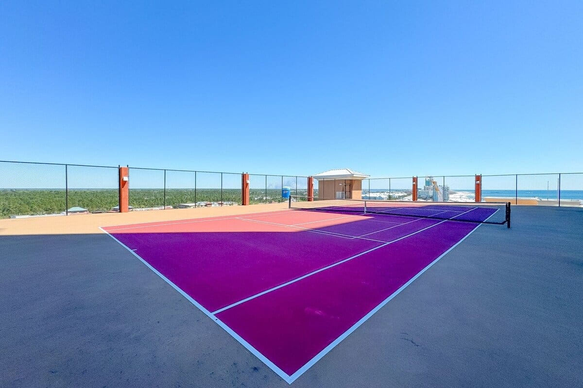 Purple rooftop tennis court view.