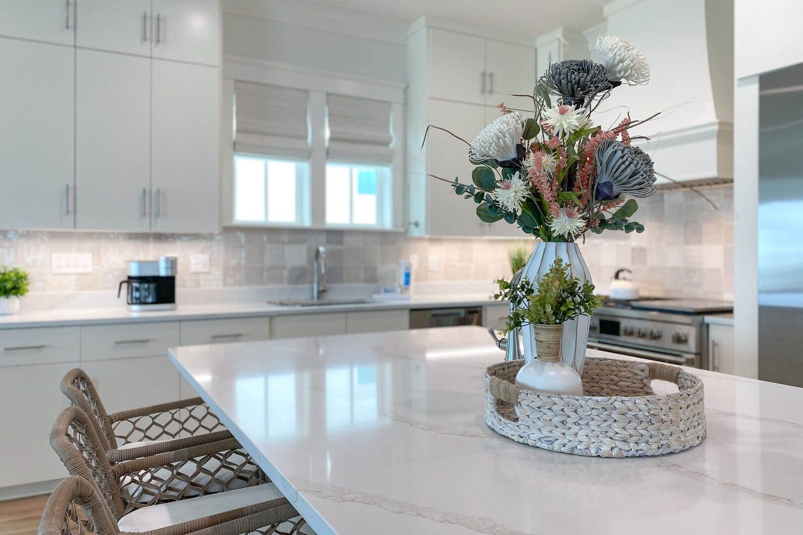 Modern kitchen with floral centerpiece.