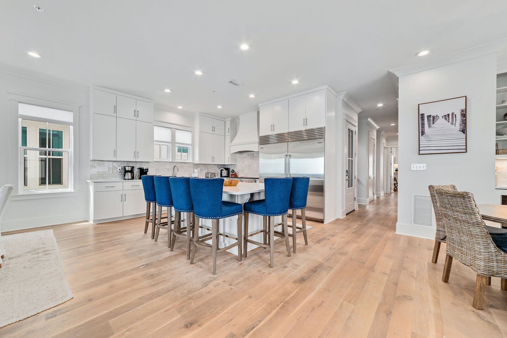 Modern kitchen with blue chairs.