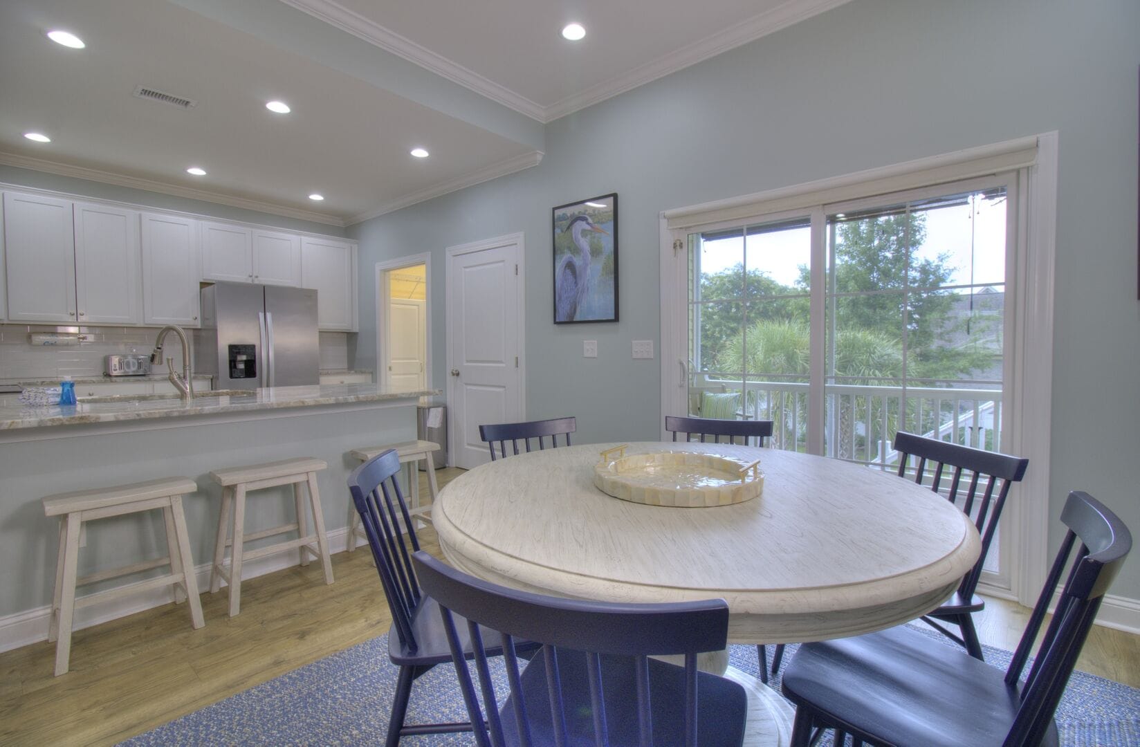 Modern kitchen-dining area with table.