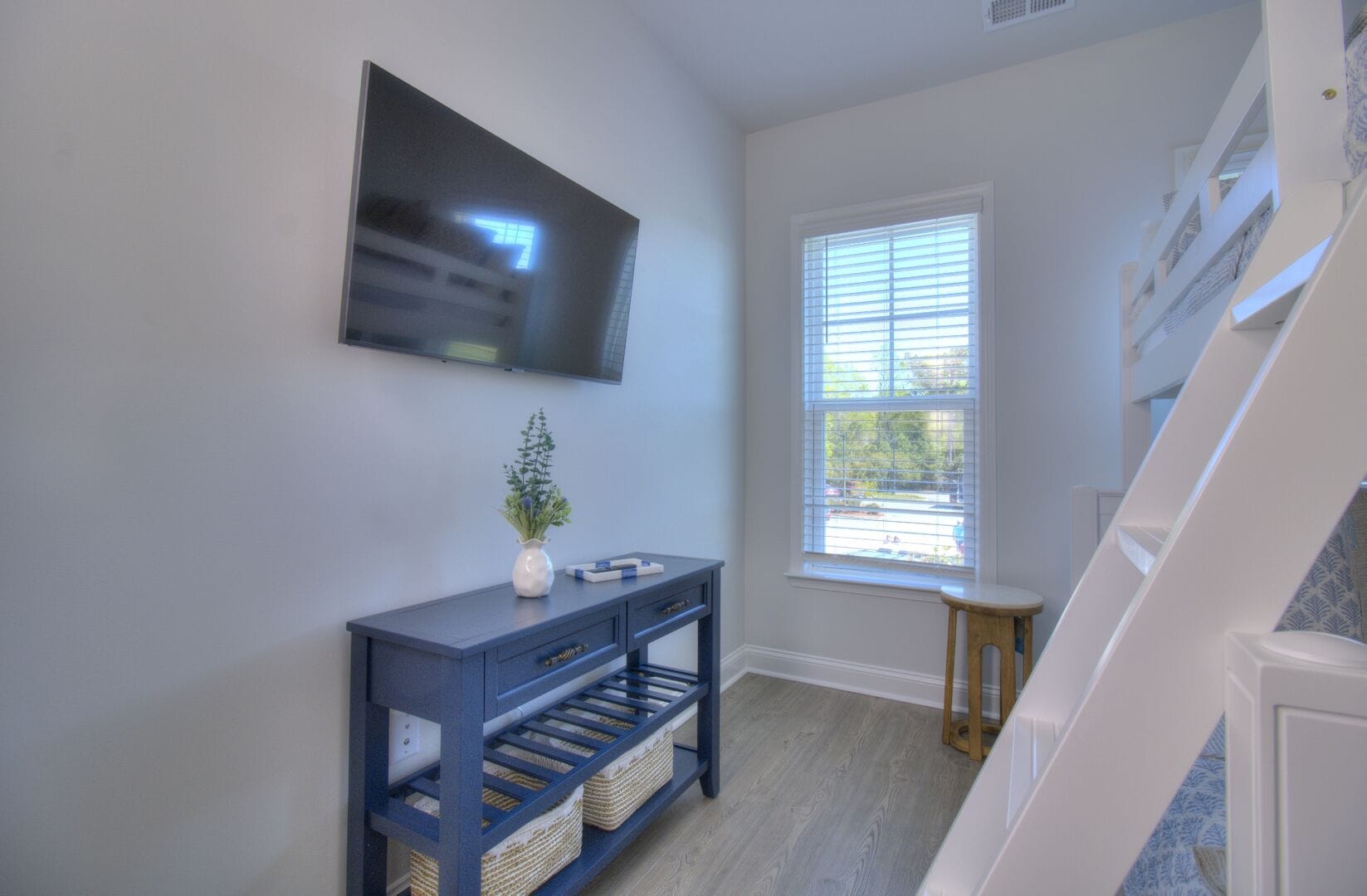 Room with bunk bed and TV.