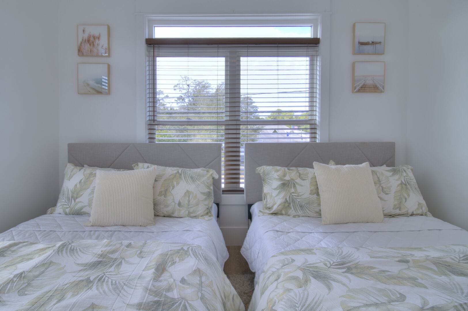 Twin beds with patterned bedding.