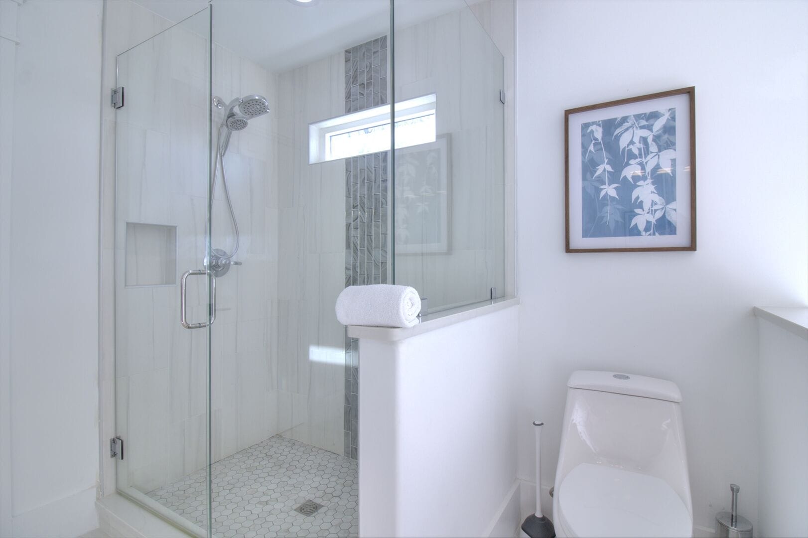 Modern bathroom with shower and toilet.