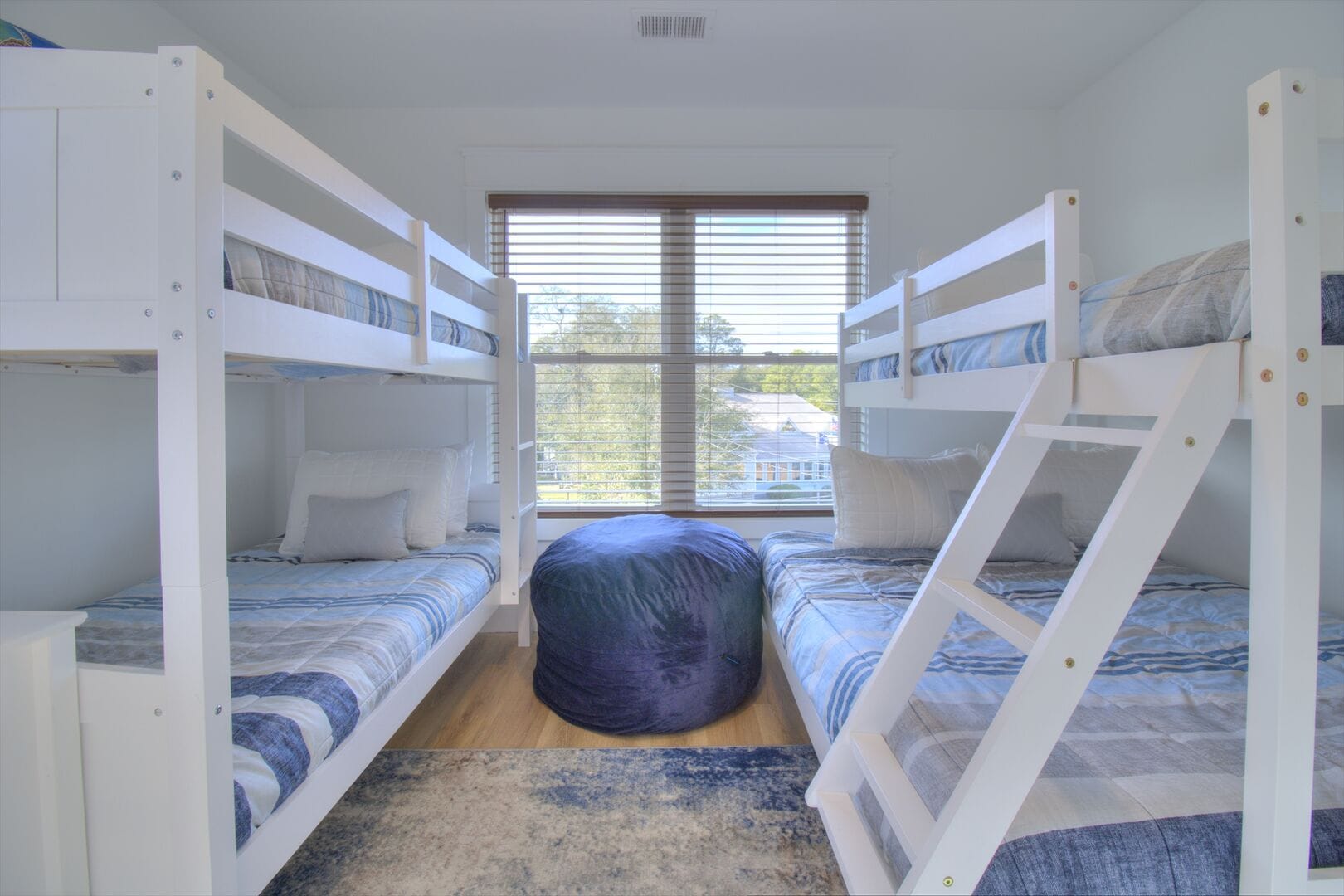 Room with bunk beds, window view.