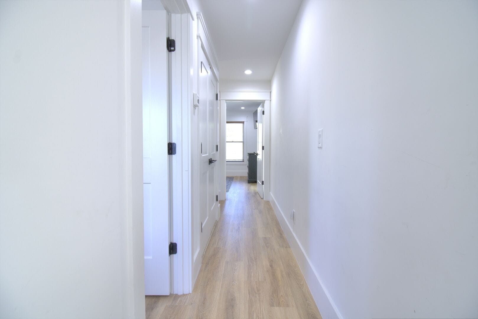 Bright hallway with wooden floor.