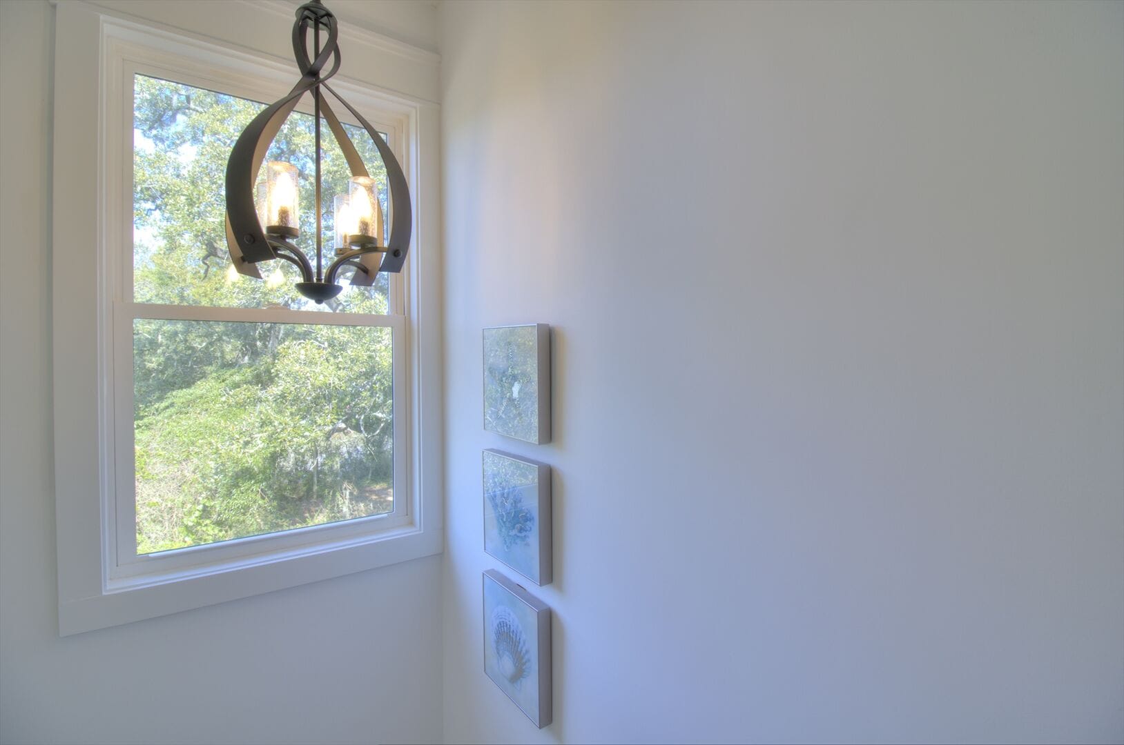 Staircase window with decorative chandelier.