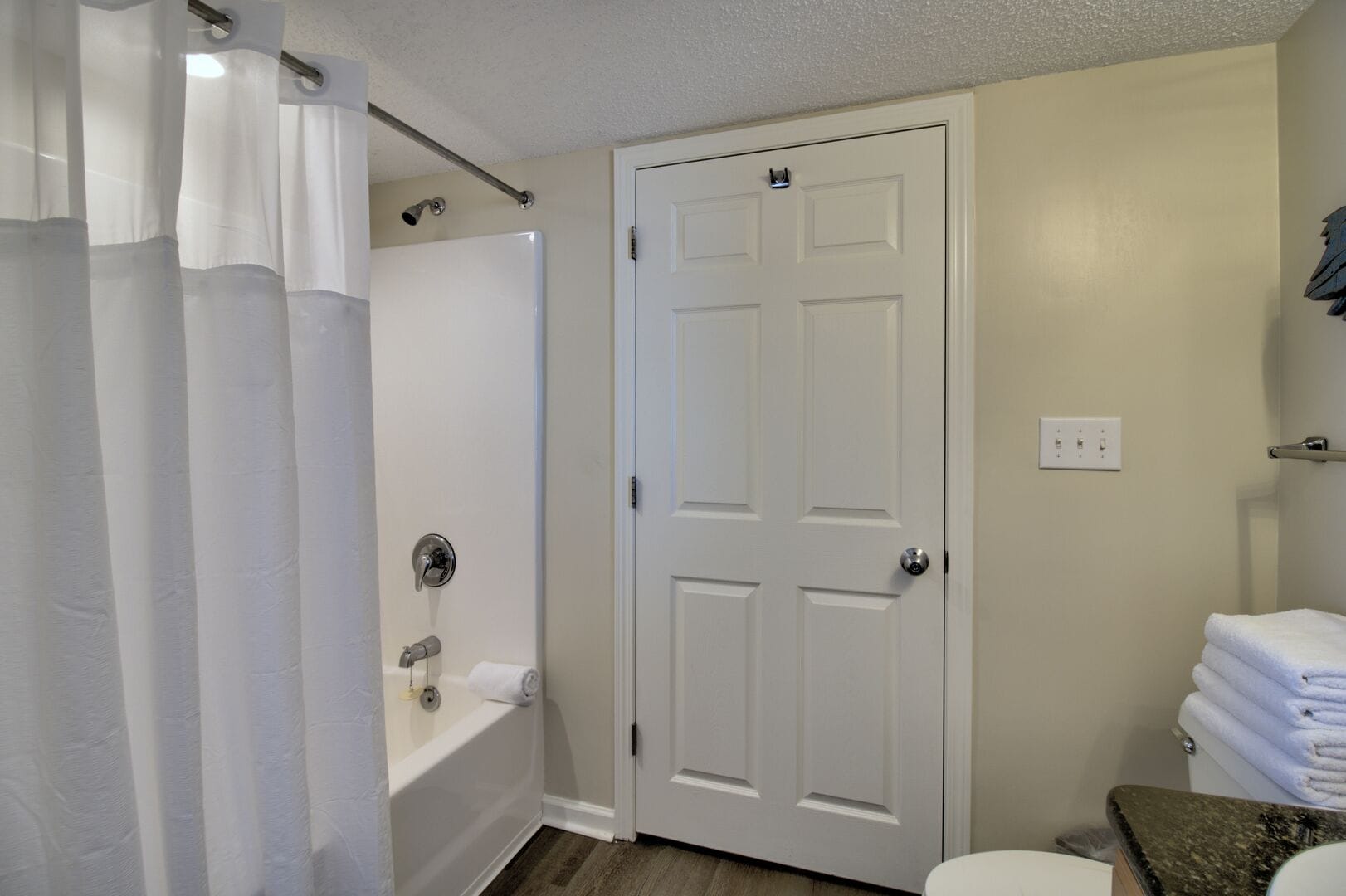 Bathroom with shower and towels.