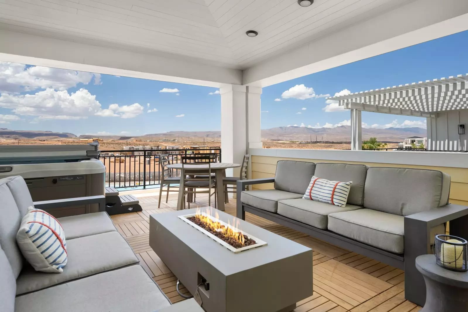 Outdoor patio with sofas and fireplace.