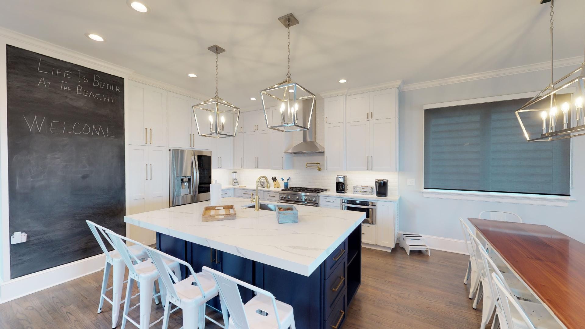 Modern kitchen with island and chalkboard.