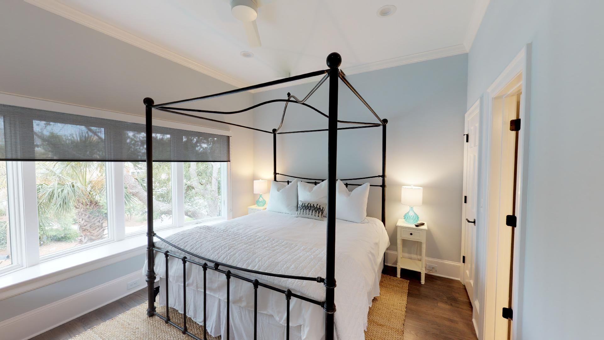 Bedroom with canopy bed and lamp.