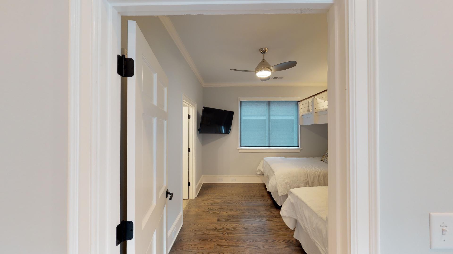 Bedroom with two beds and TV.