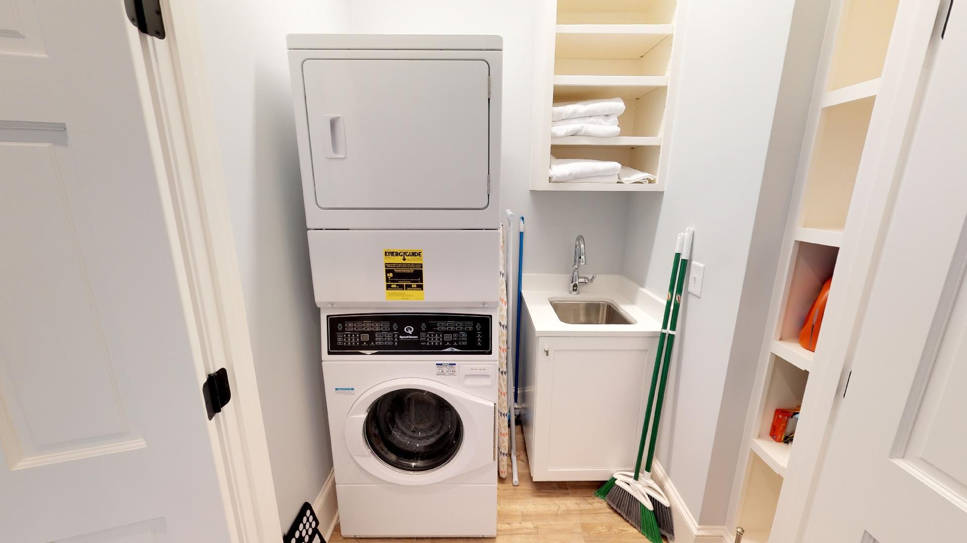 Laundry room with stacked washer-dryer.