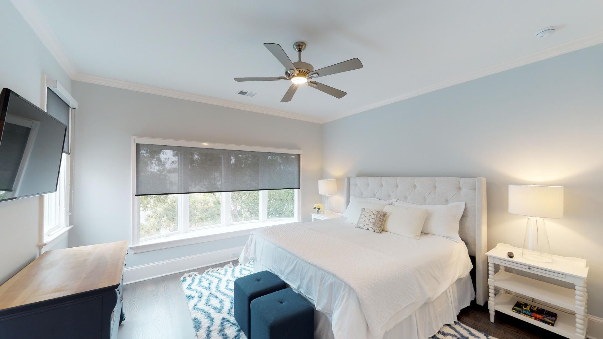 Elegant bedroom with ceiling fan.