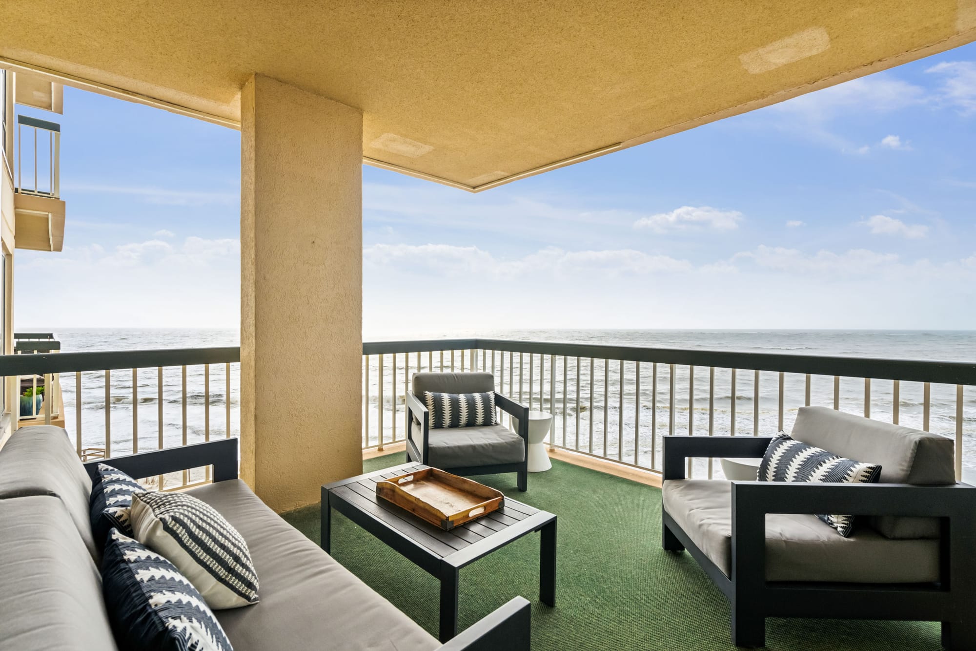 Balcony with ocean view, seating.