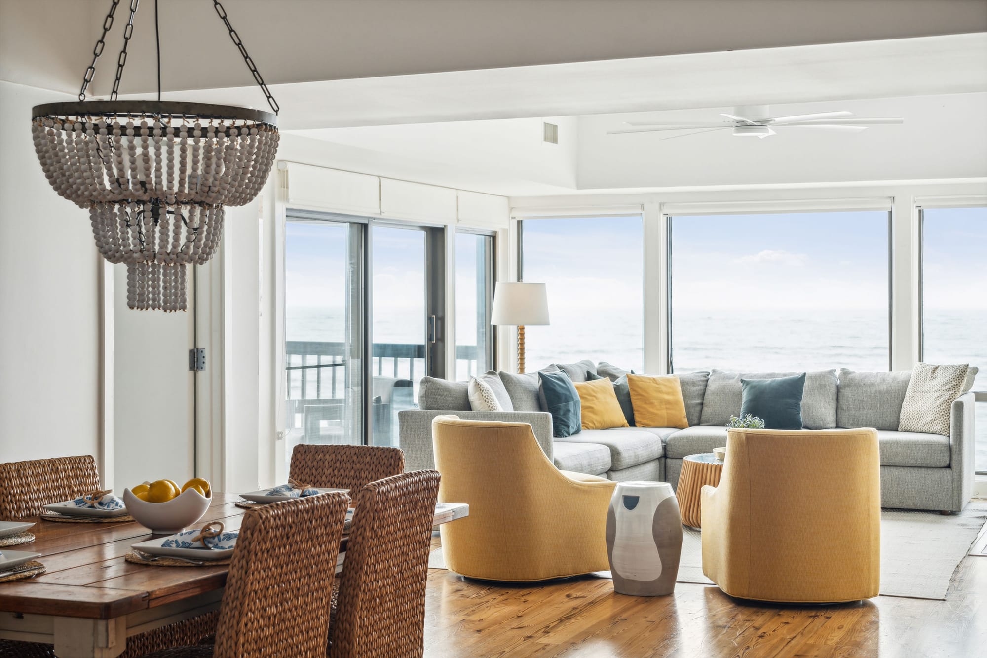 Coastal living room with large windows.