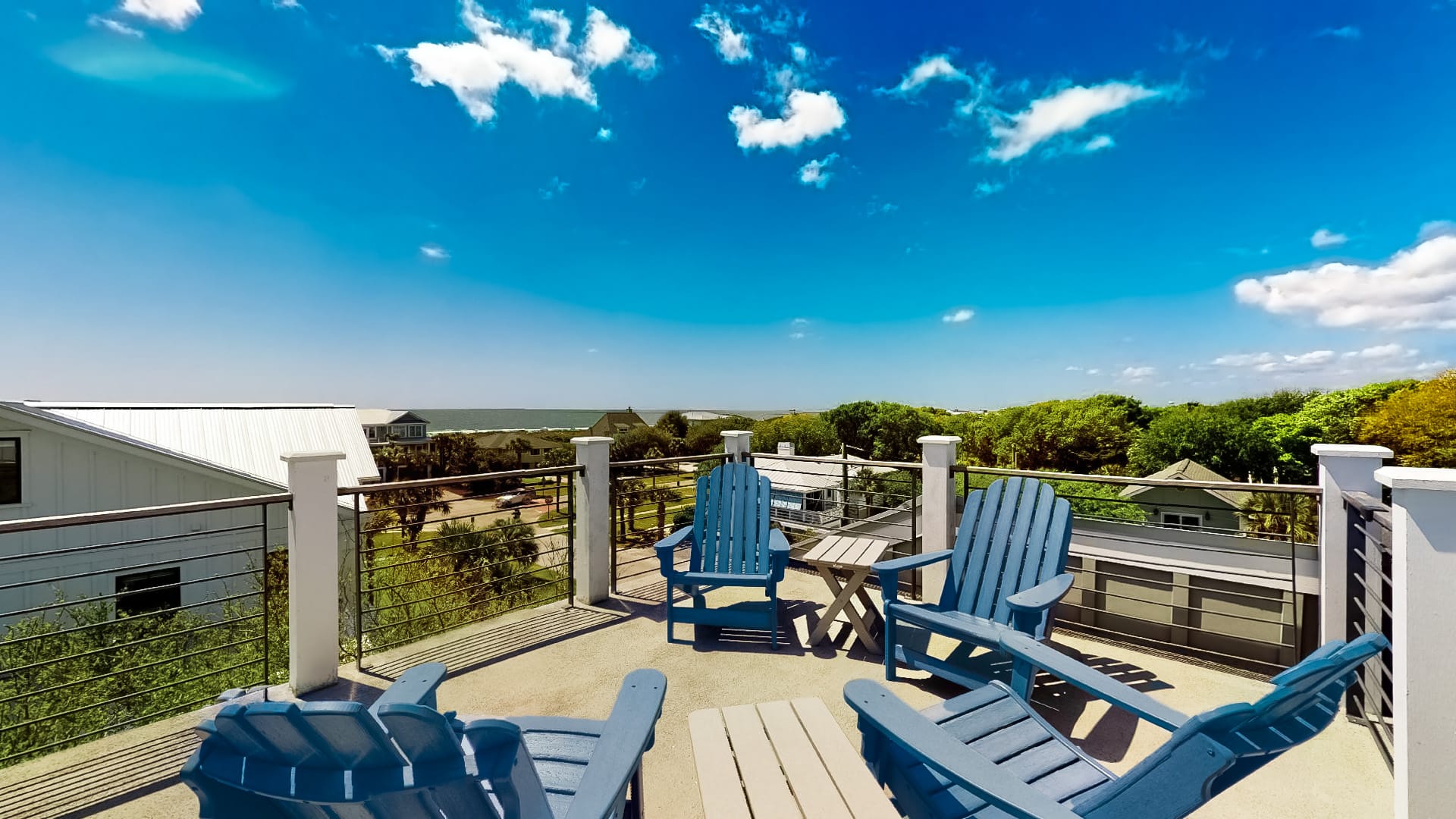 Rooftop deck with blue chairs.