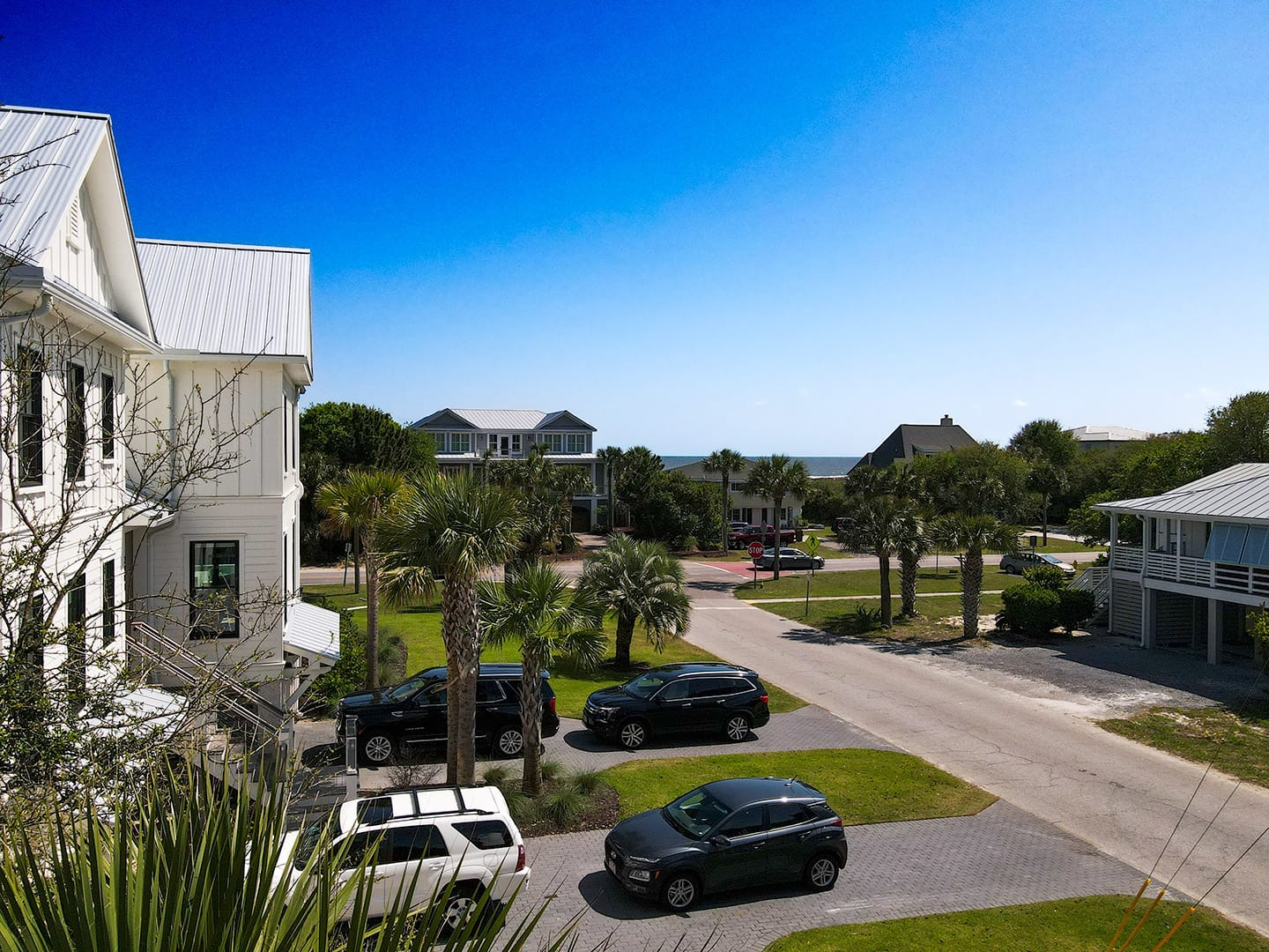 Coastal neighborhood with parked cars.