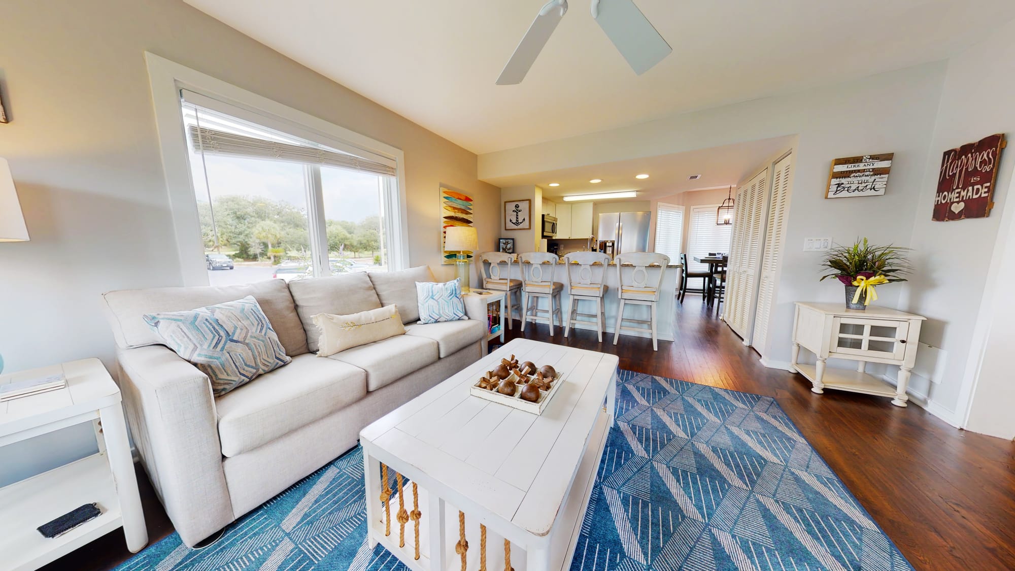 Bright, cozy living room with kitchen.