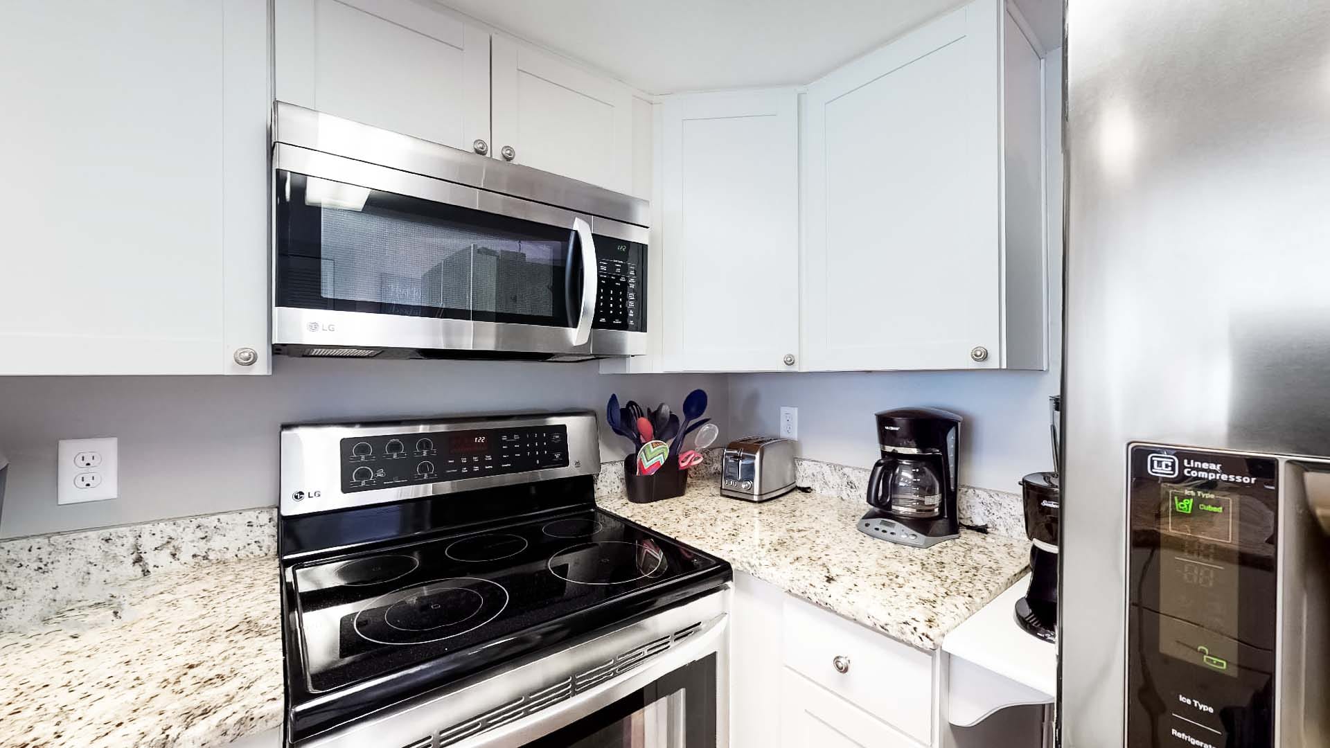 Modern kitchen with appliances and countertops.