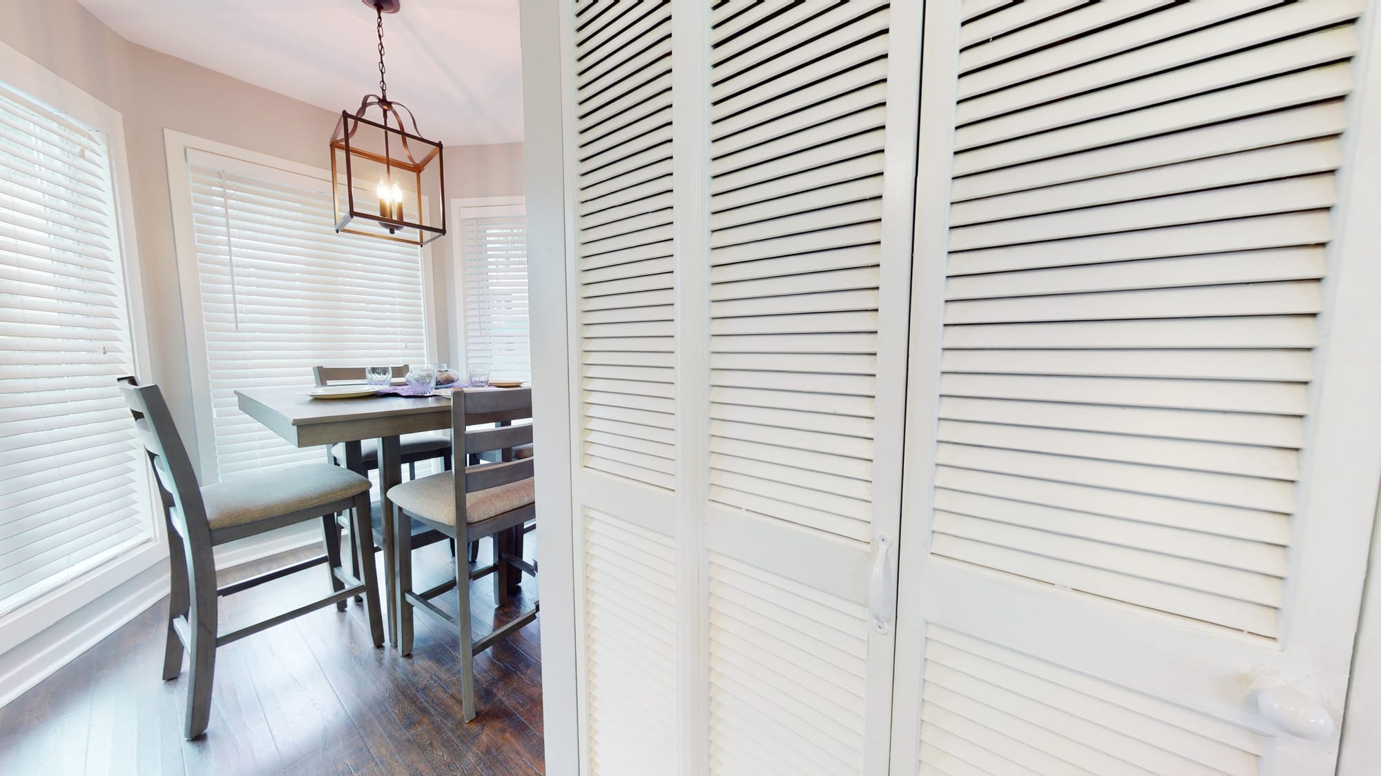 Dining area beside louvered doors.