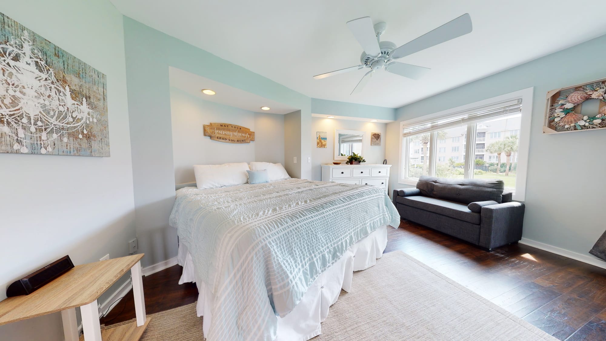 Bright bedroom with bed, sofa.