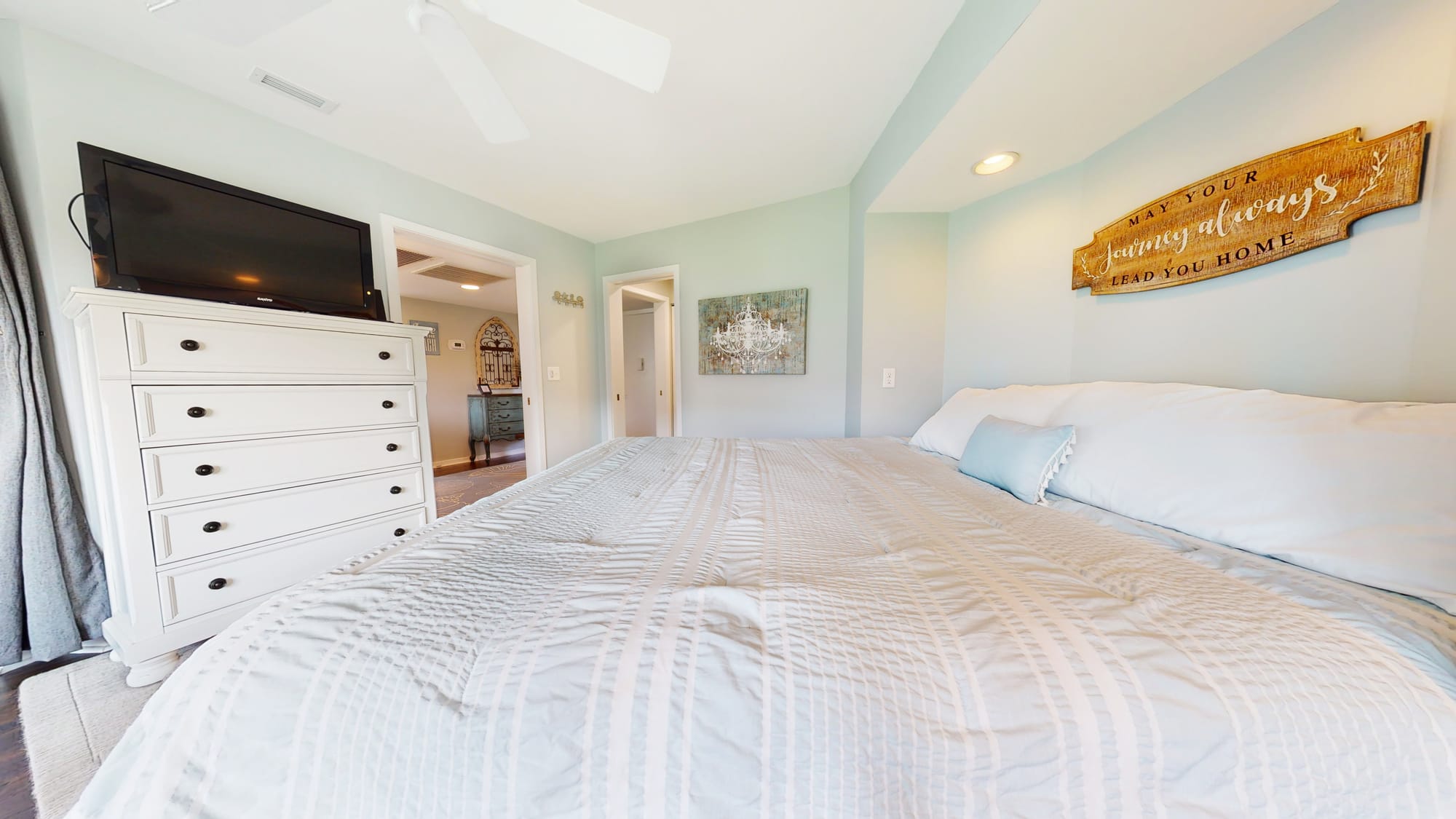 Bedroom with bed and dresser.