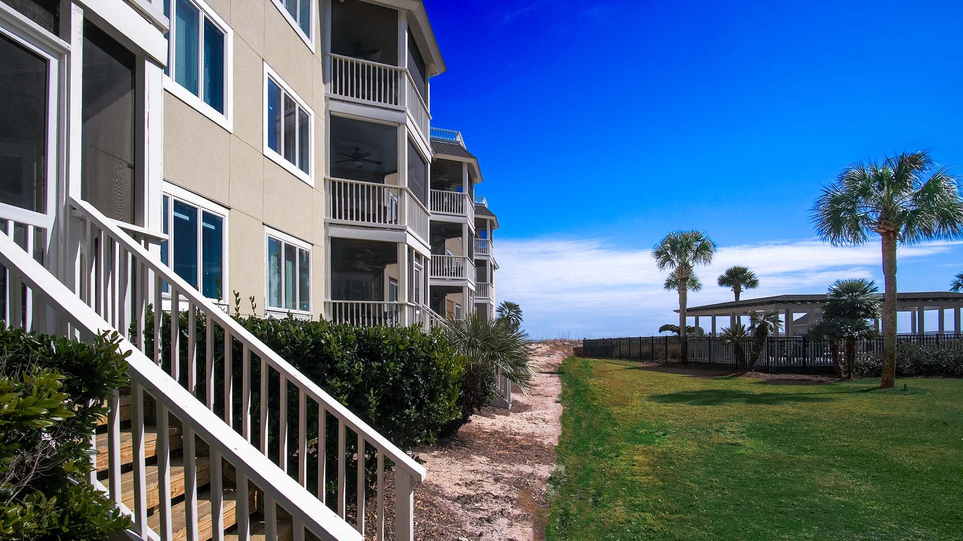 Beachfront condos with palm trees.