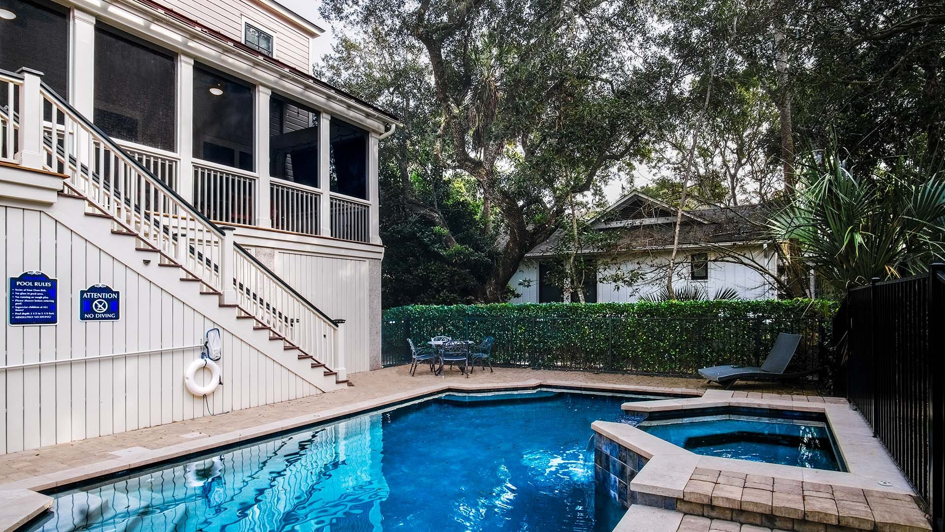 House with pool and patio furniture.