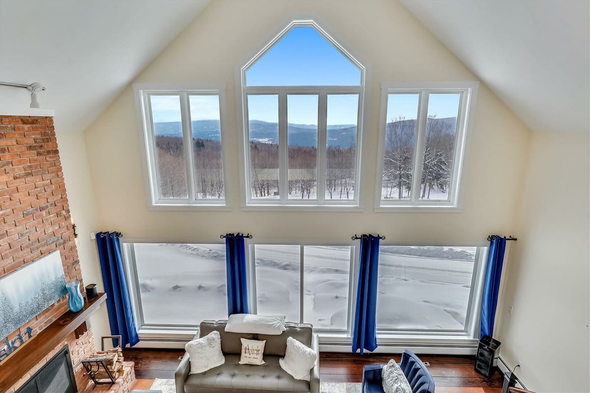 Living room with large snowy windows.