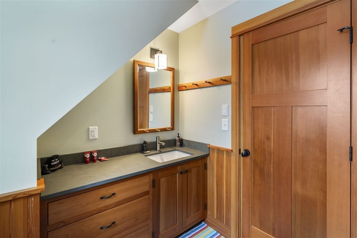 Cozy bathroom with wooden cabinets.