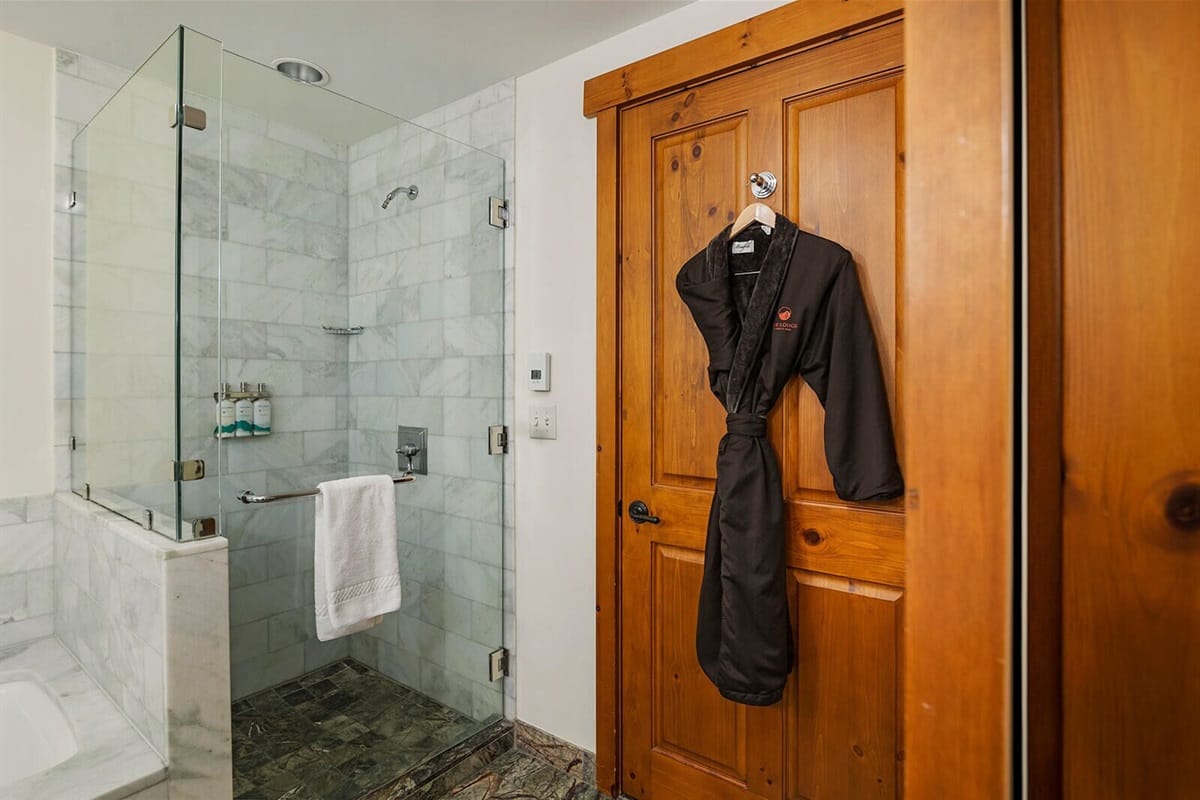 Bathroom with robe on door.