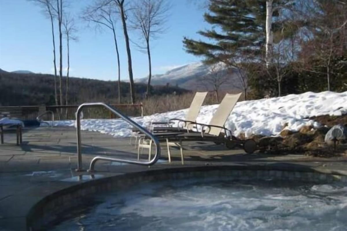 Snowy outdoor hot tub scene.