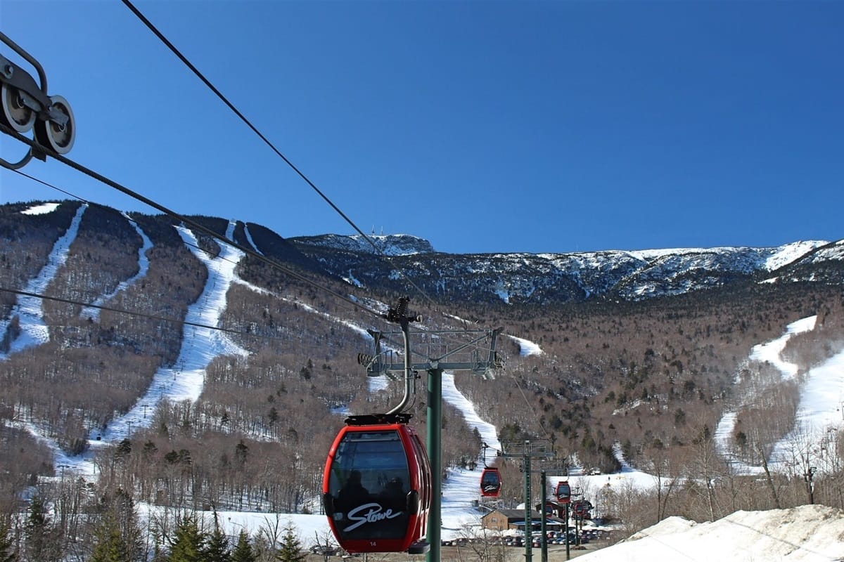 Ski gondolas and snowy mountain.