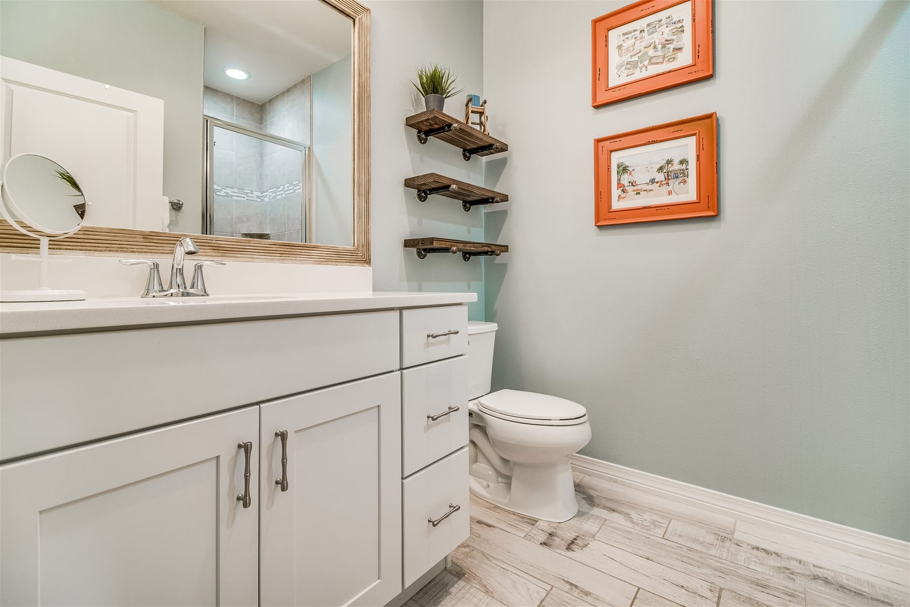 Modern bathroom with vanity and shelves.