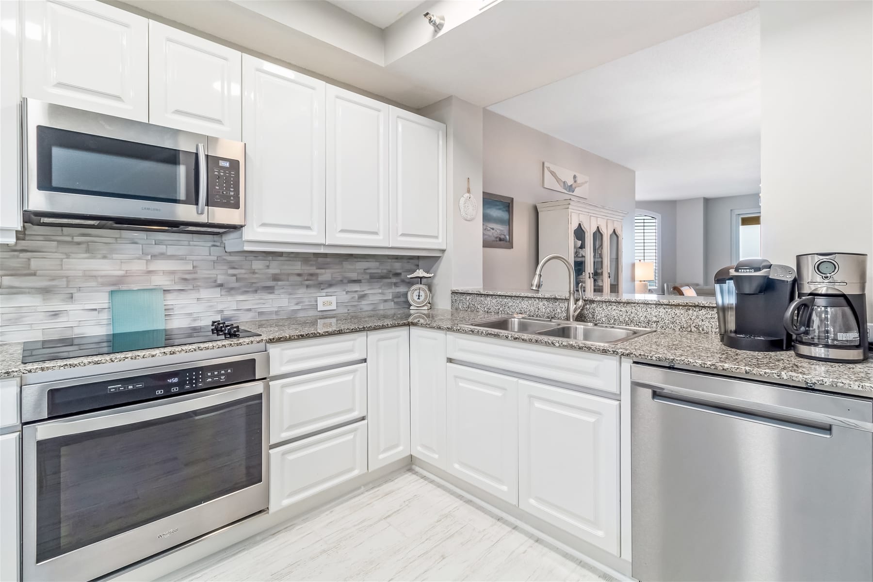 Modern kitchen with stainless steel appliances.