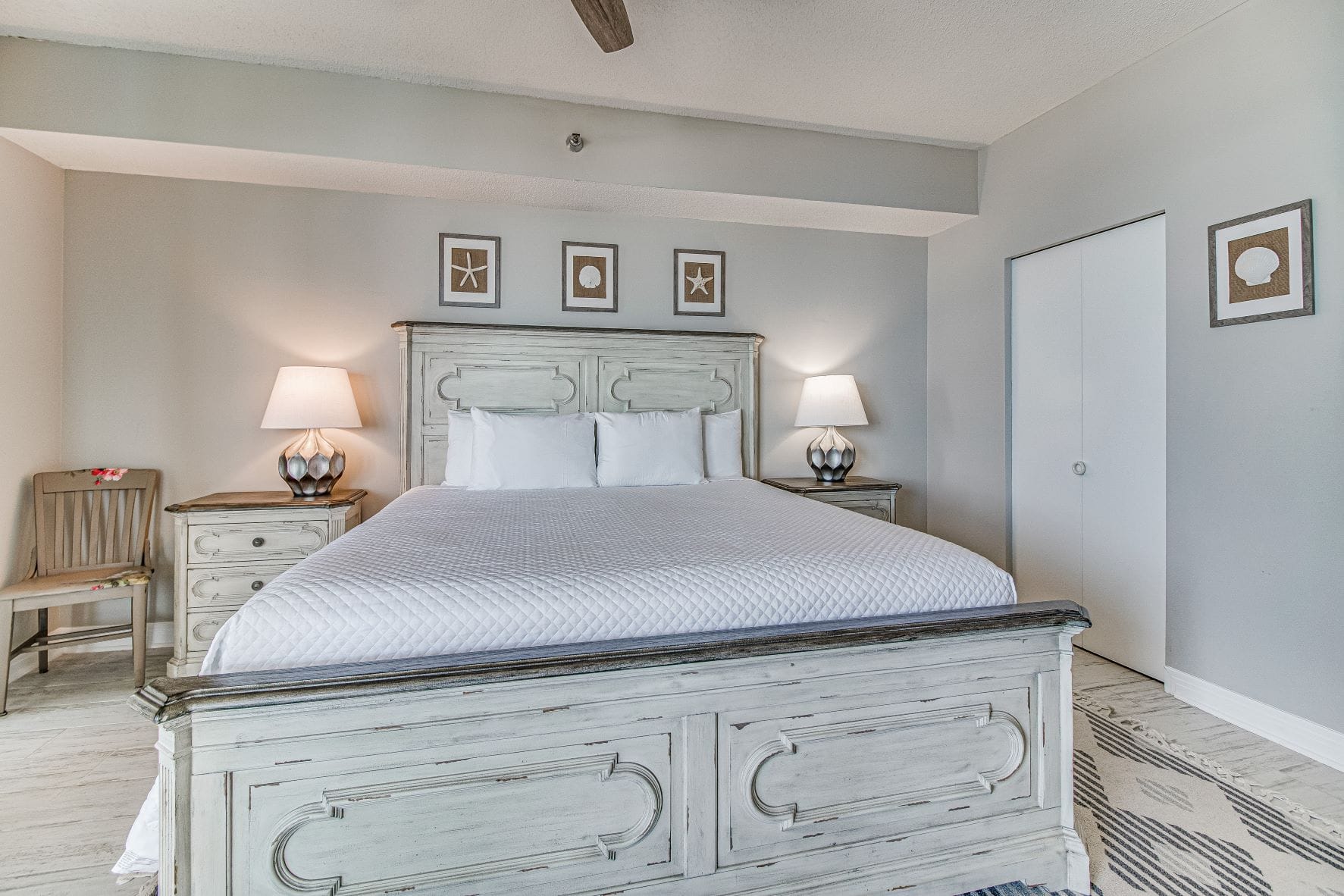 Coastal-themed bedroom with white bed.