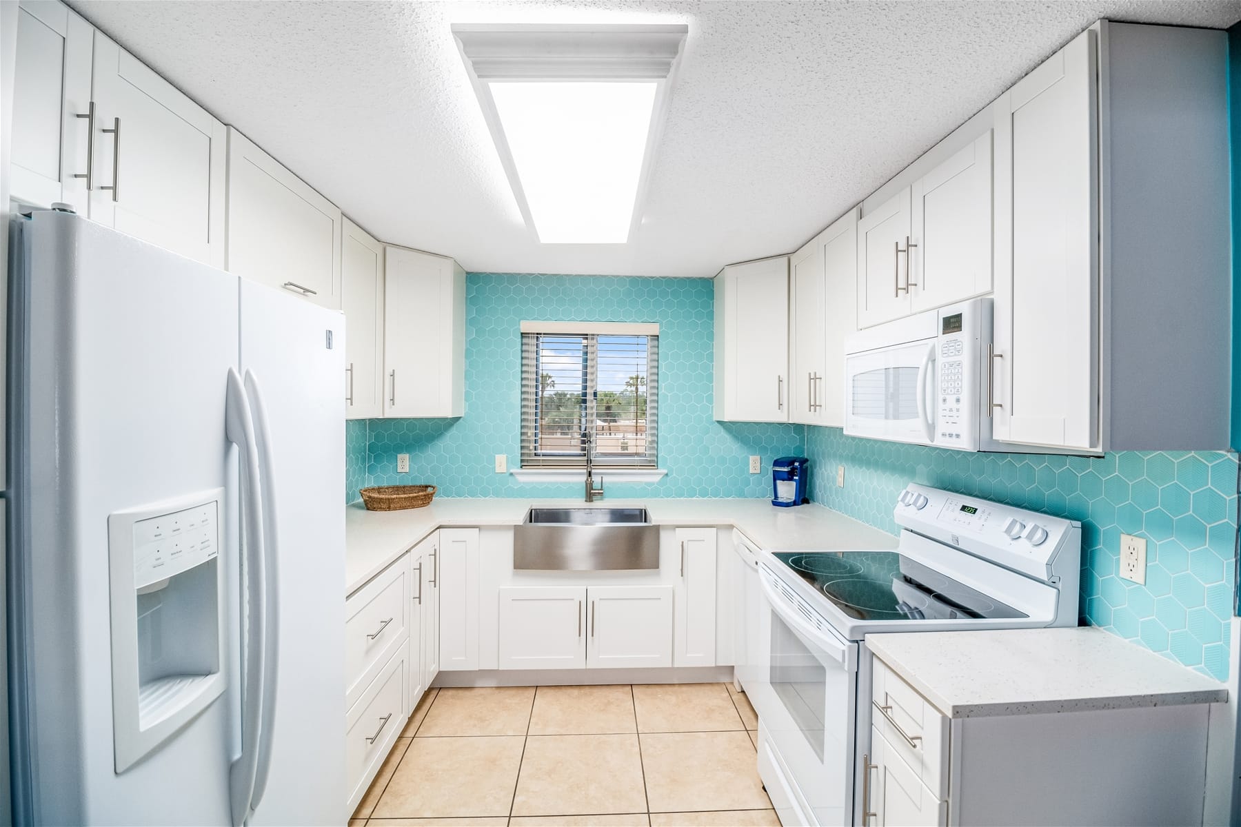 Bright kitchen with blue backsplash.