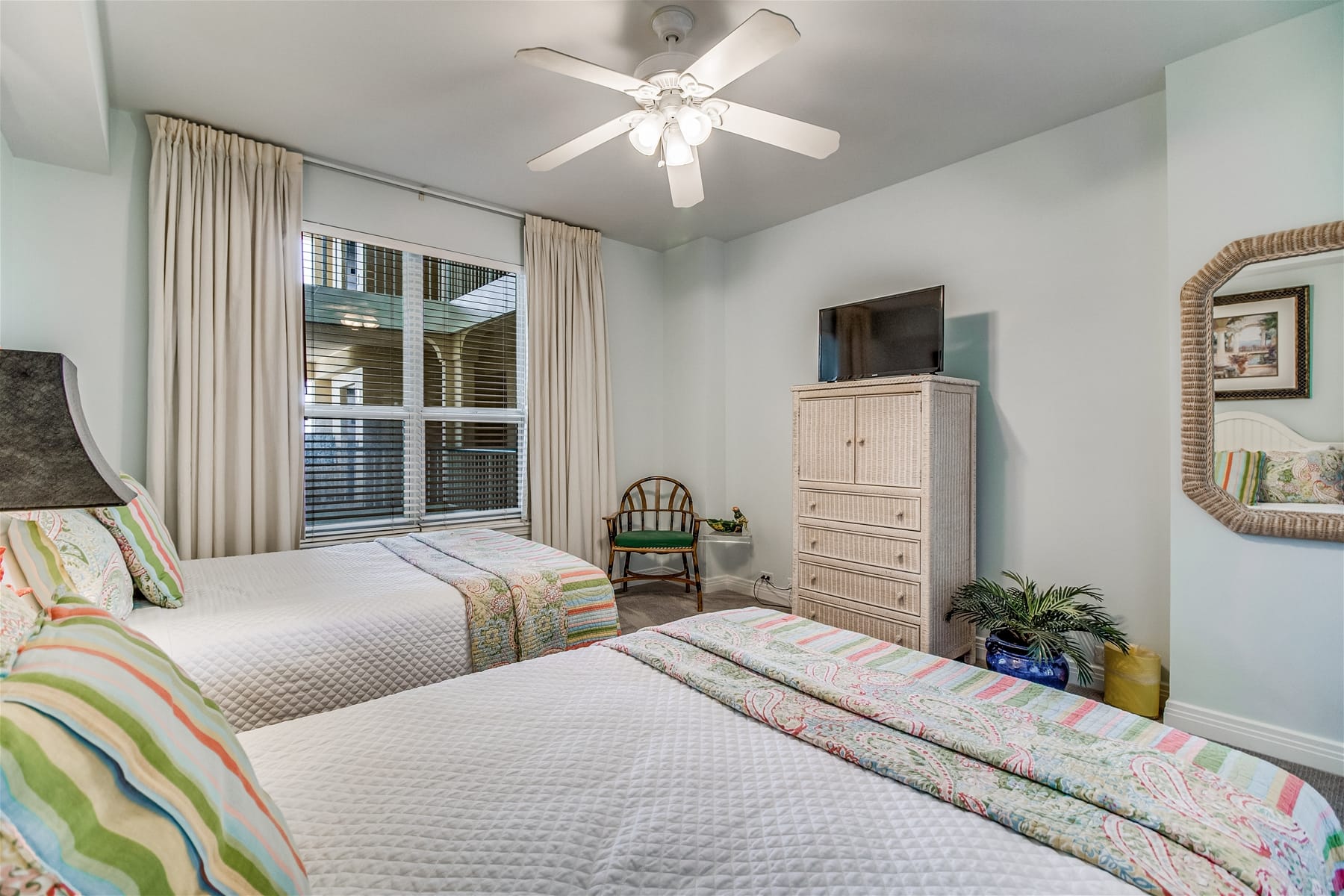 Bedroom with two beds, dresser.