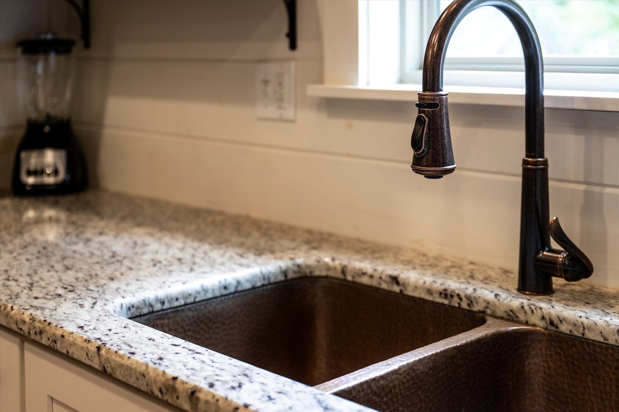 Kitchen sink with granite countertop.