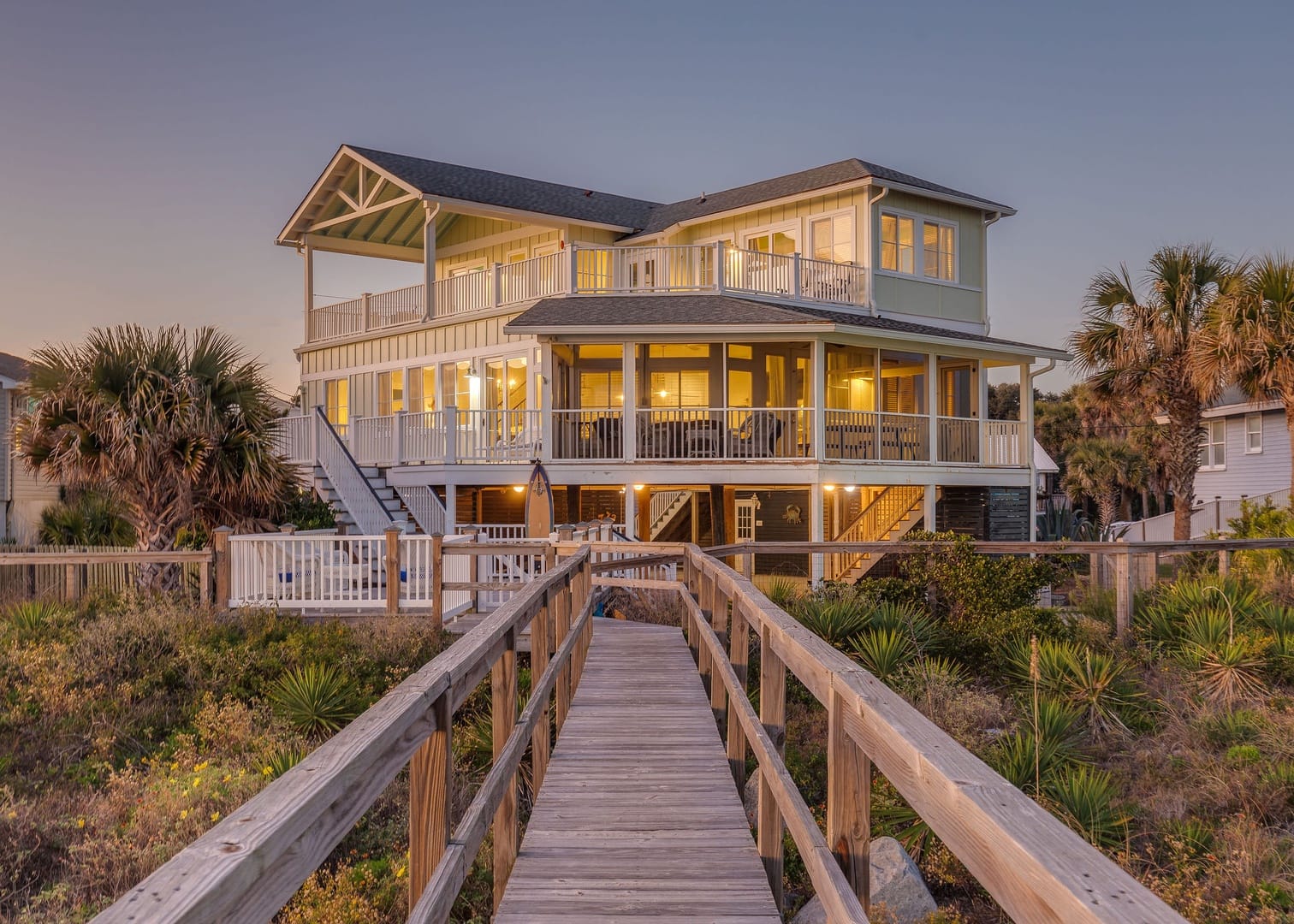 Coastal house with wooden walkway.