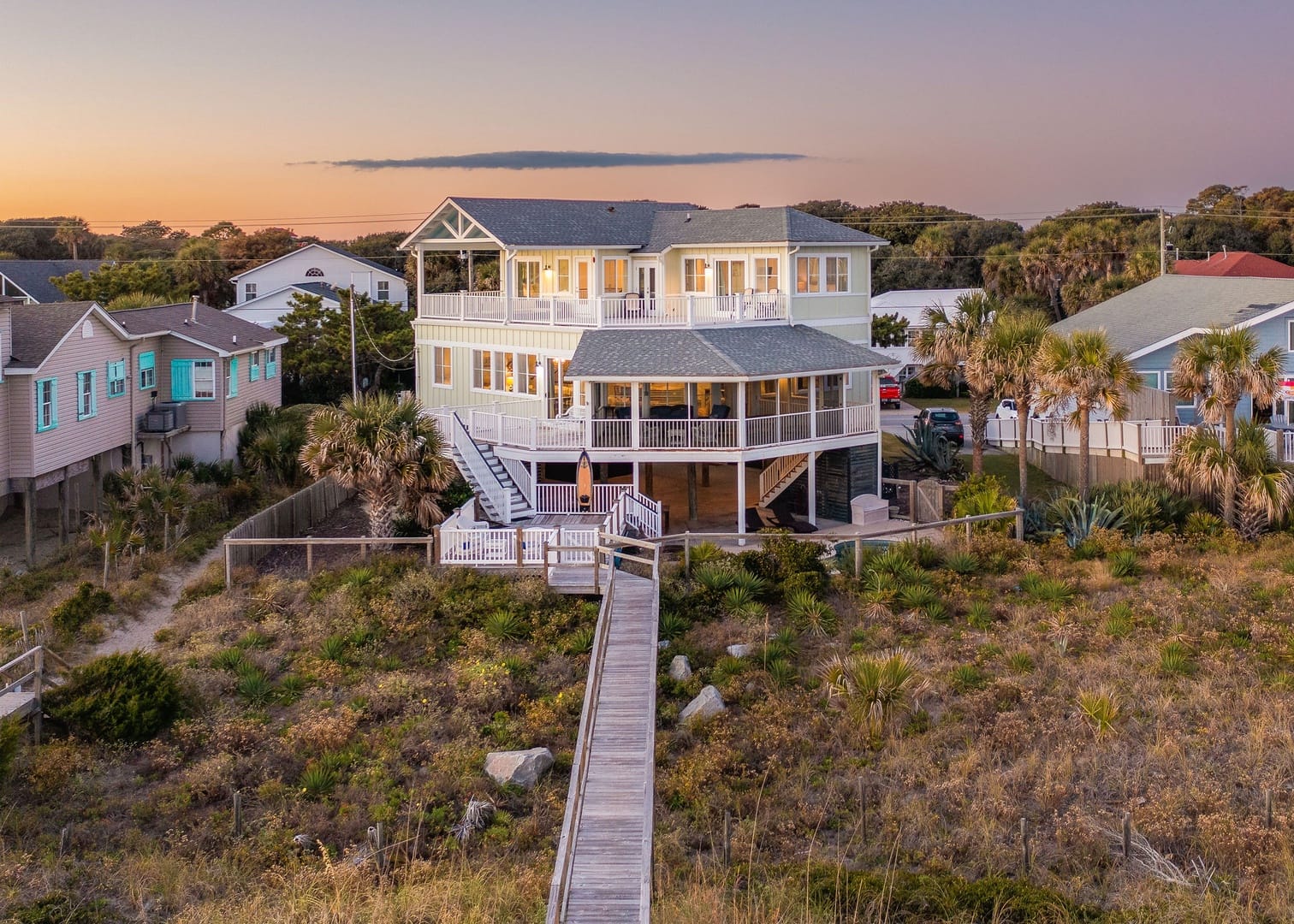 Beach house with wooden walkway.