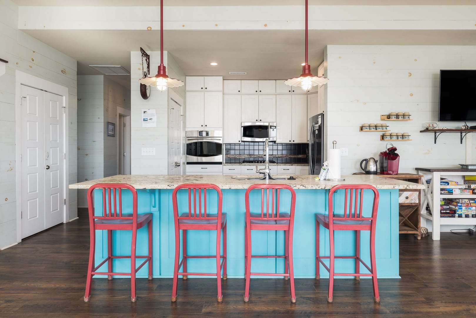 Bright kitchen with red chairs.