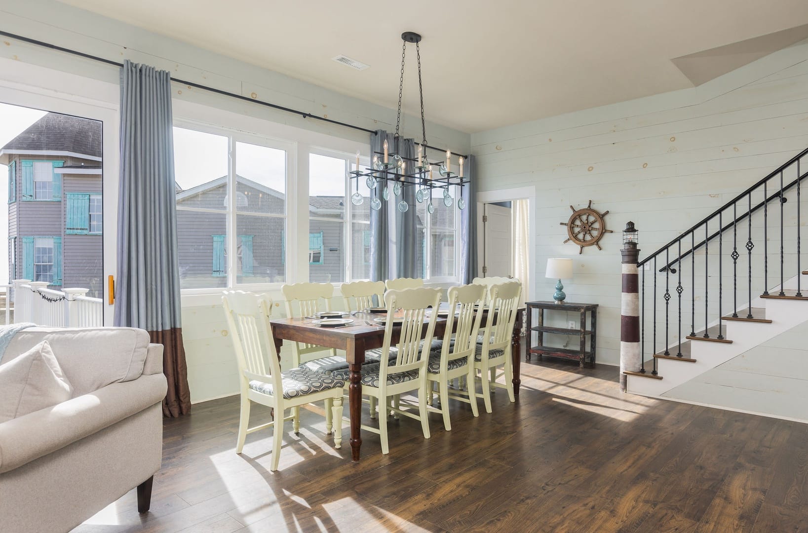 Coastal dining room with staircase.